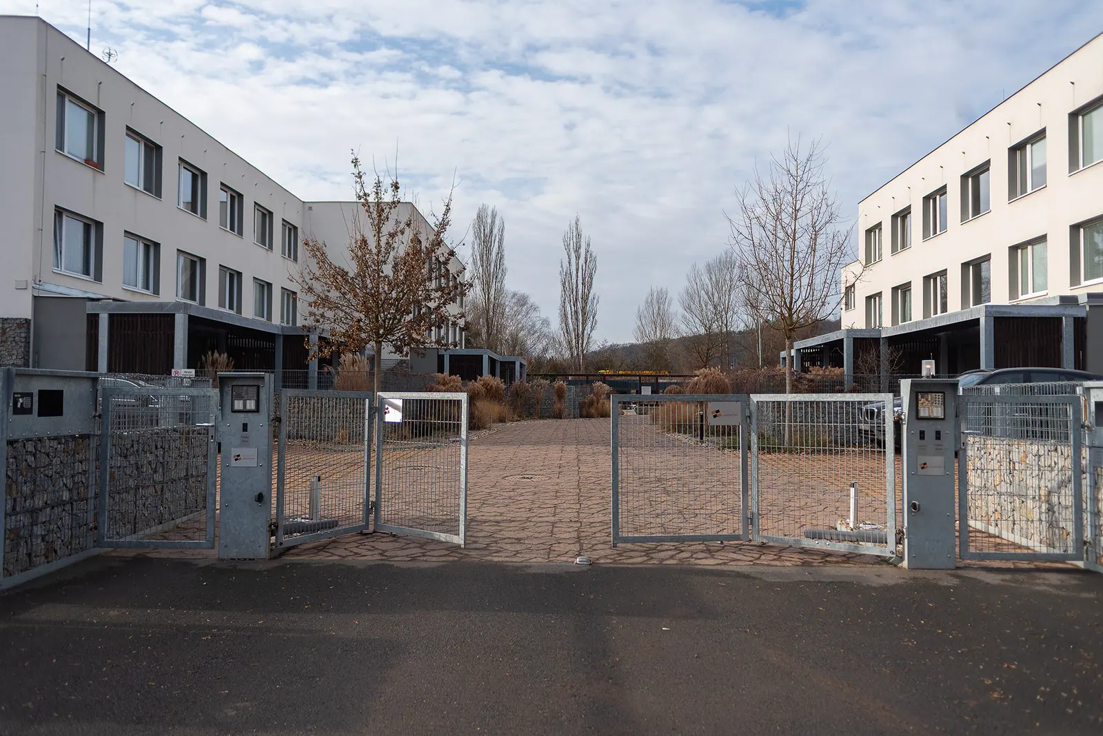 The residence buildings, with parking behind the electronic gate