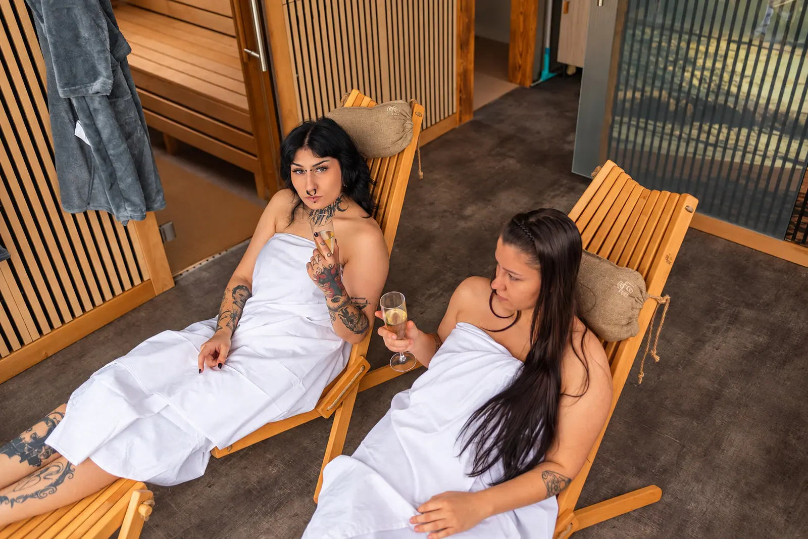 Guests resting on loungers by the water