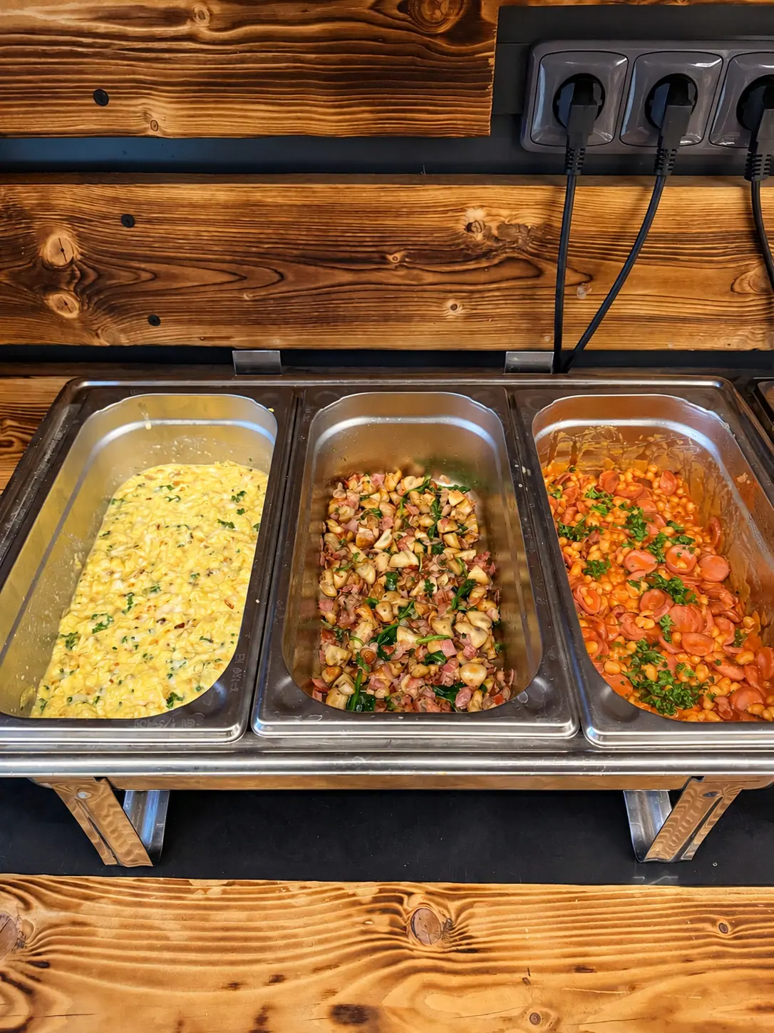 Scrambled eggs, mushrooms and beans in chafing dishes
