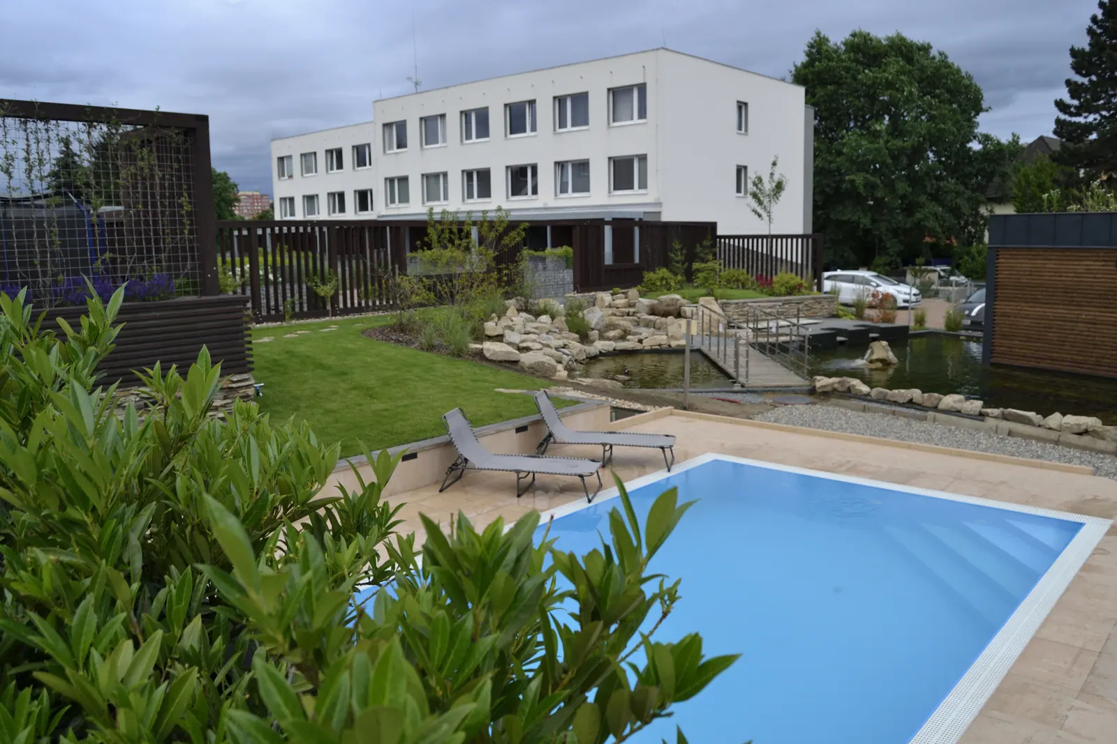 The pool, lawn and residence buildings