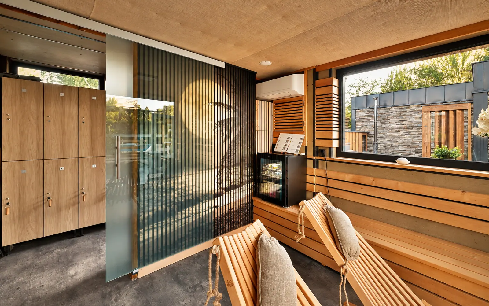 Loungers and robes by the glazed wall
