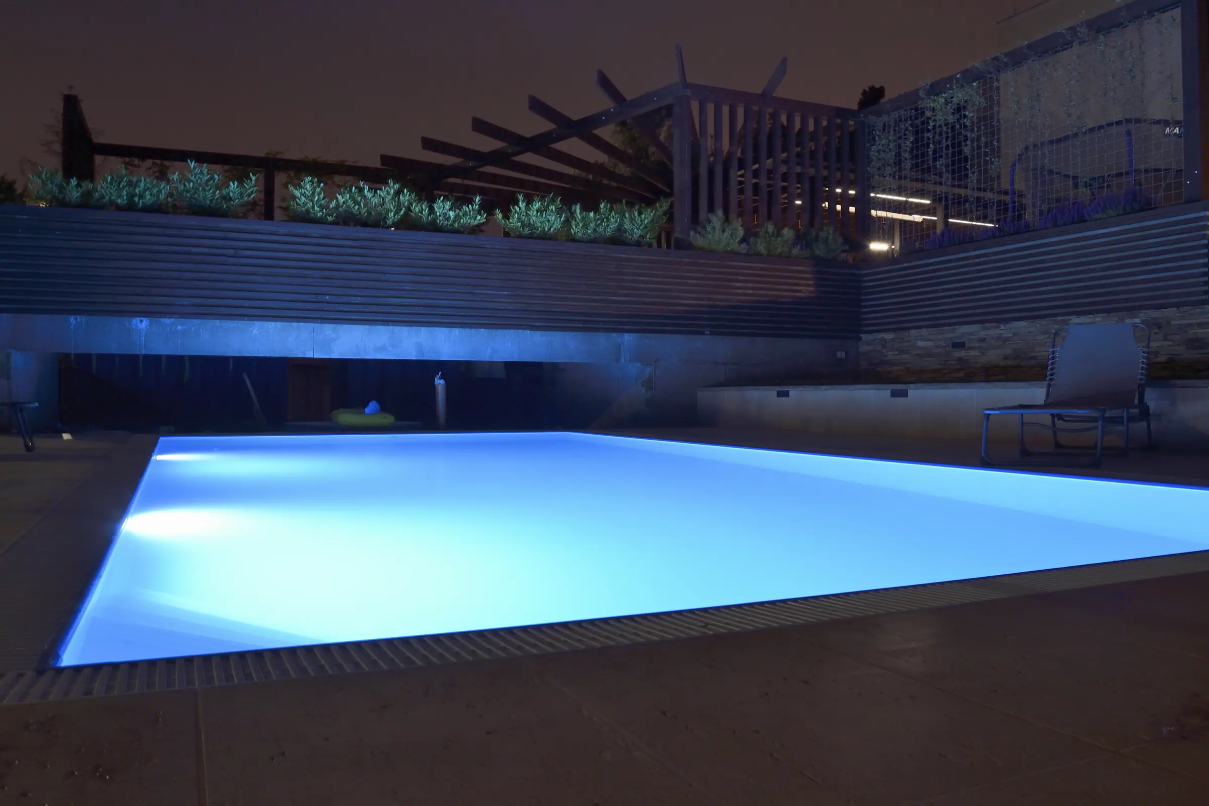 The residence pool lit after dark